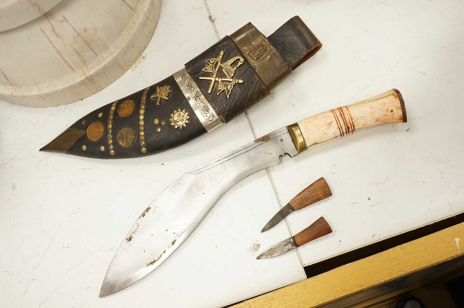 A bone handled Kukri knife, in mounted sheath